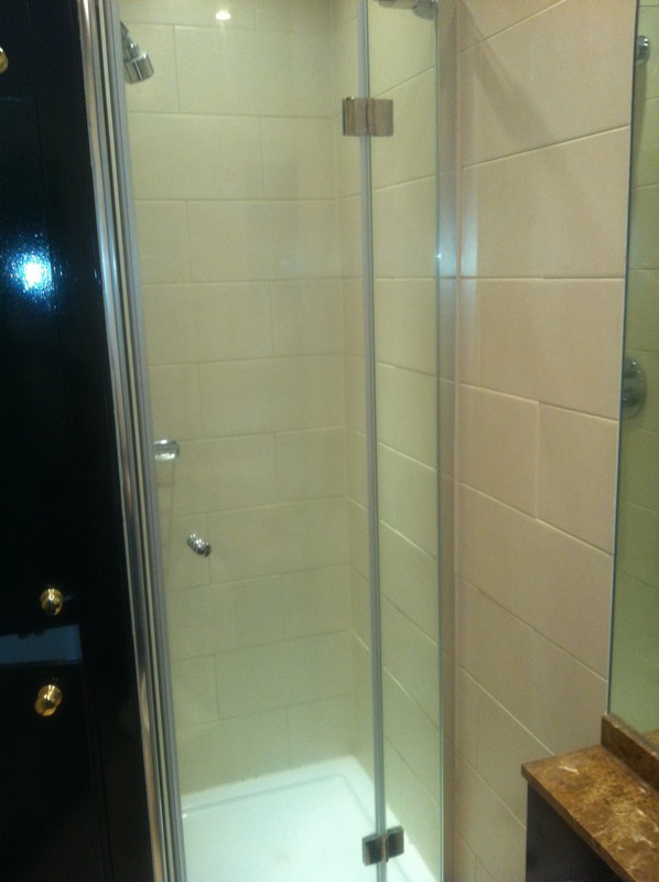 Frameless glass shower enclosure with chrome fittings in Battersea