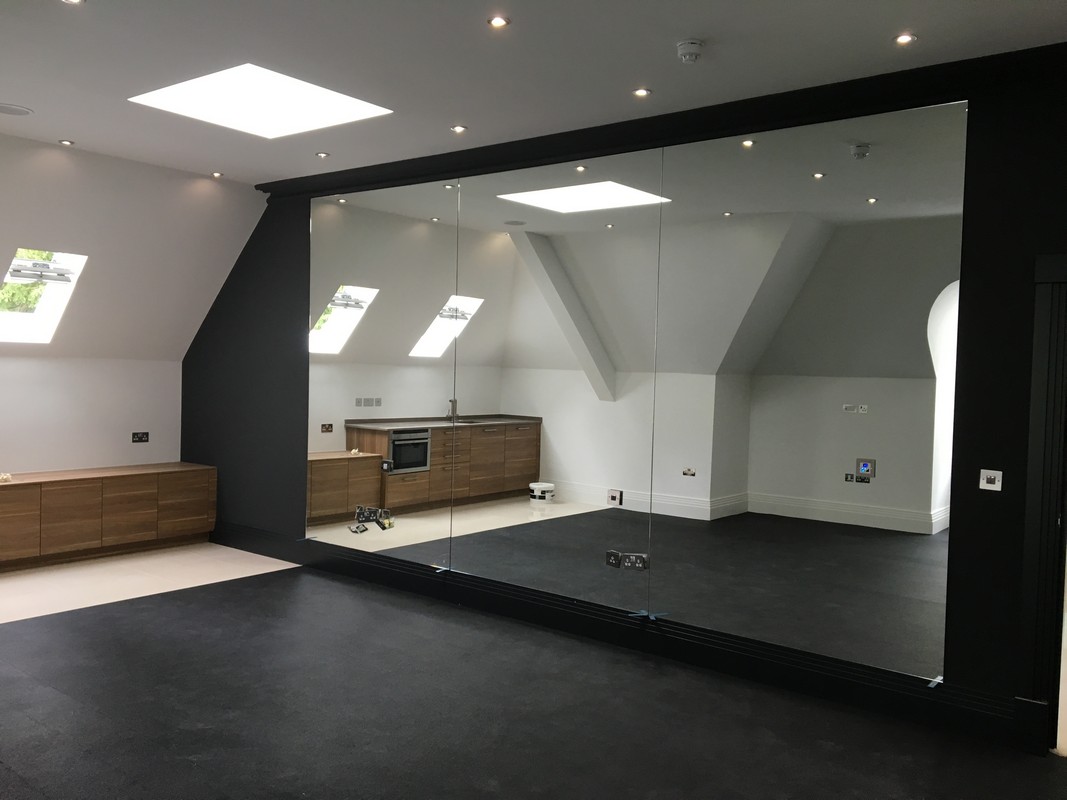 Frameless glass wall dividing loft conversion in Battersea