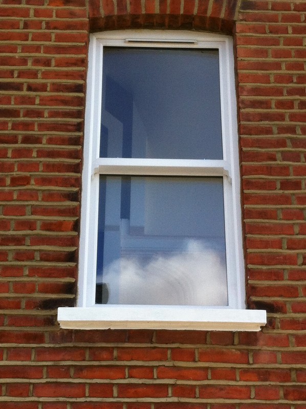 uPVC sash window on Victorian red brick house in Battersea